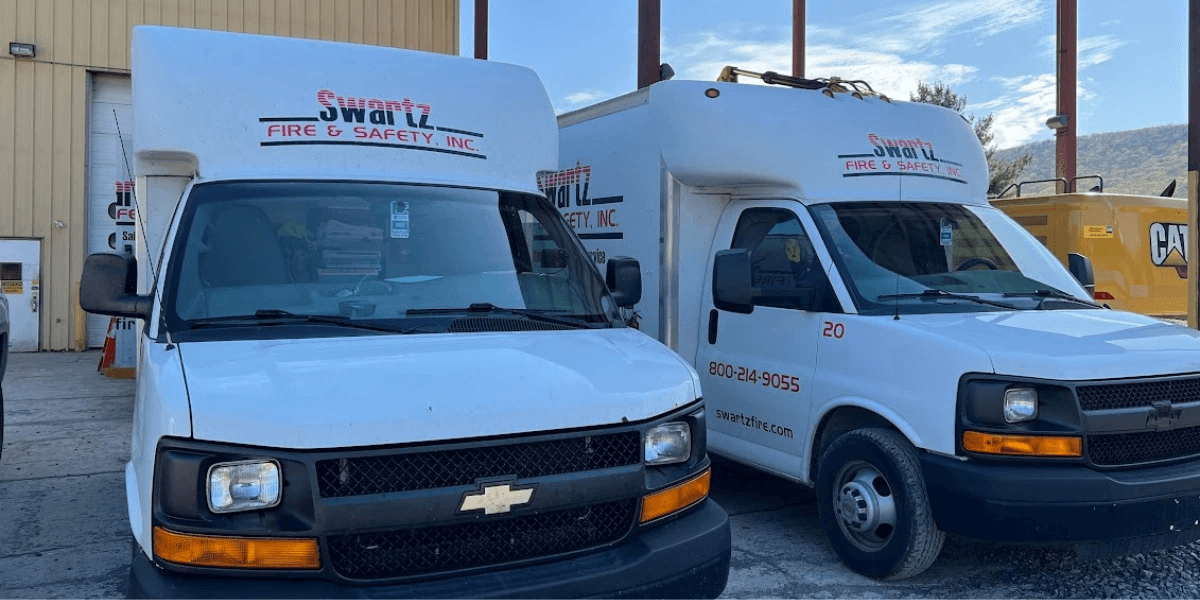 Two swartz fire safety trucks parked side by side